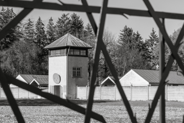 old guard tower photographed through new fence
